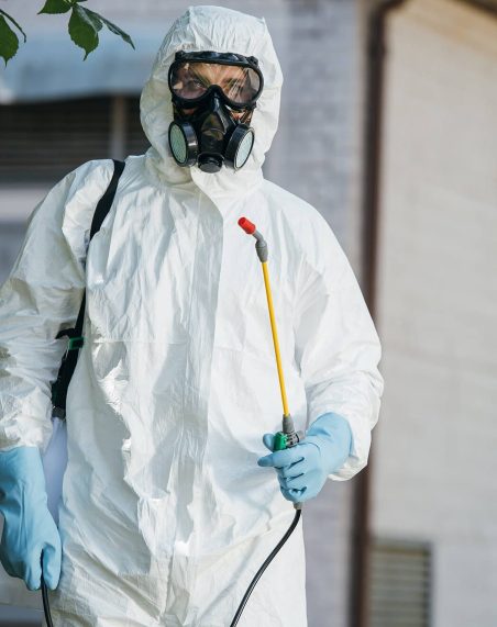 pest-control-worker-in-respirator-holding-sprayer-2021-08-29-22-36-36-utc
